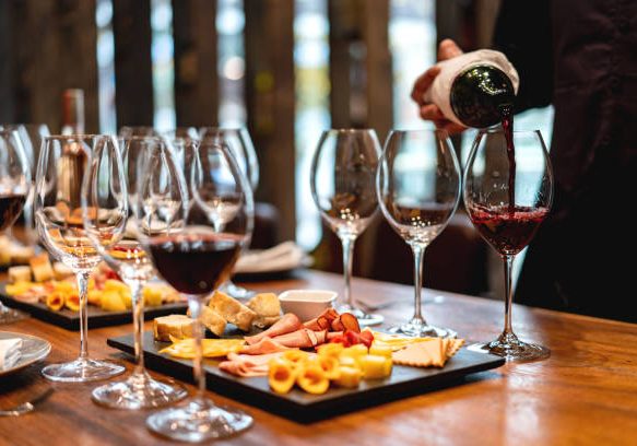 Close-up on a sommelier serving glasses of winetasting event