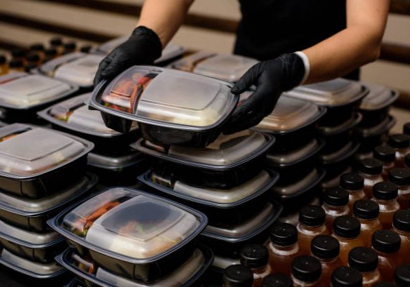 Lunch box with food in the hands. Catering