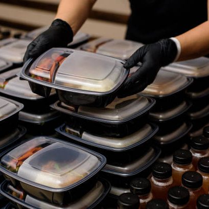 Lunch box with food in the hands. Catering