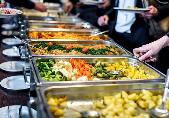 Cuisine Culinary Buffet Dinner Catering Dining Food Celebration Party Concept. Group of people in all you can eat catering buffet food indoor in luxury restaurant with meat and vegetables.